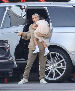 Kim Kardashian carrying a sleepy princess Nori