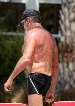 Baywatch actor David Hasselhoff wears tiny black swim trunks as he relaxes with his bikini clad finance Hayley Roberts by the pool in Miami.