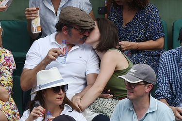 Jean Dujardin and his wife Nathalie Pechalat keep each other moisturised at the French Tennis Open at Roland Garros