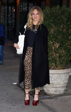 Juno Temple is pictured chatting on a cellphone outside her hotel in New York City.