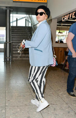 Rita Ora in a Striped Track Suit at Heathrow Airport