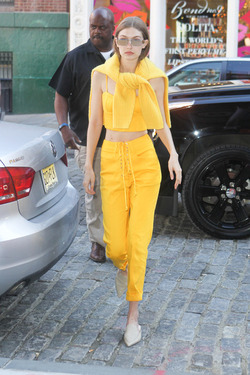 Gigi Hadid wears an all yellow ensemble as she arrives at her apartment
