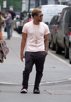 Usher wears comical slippers as he walks in Tribeca