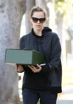 Jennifer Garner carries a school project as she takes her kids to school