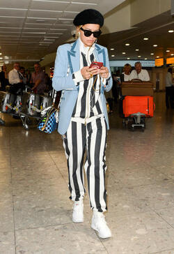Rita Ora in a Striped Track Suit at Heathrow Airport
