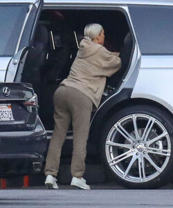 Kim Kardashian carrying a sleepy princess Nori