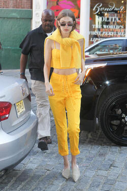 Gigi Hadid wears an all yellow ensemble as she arrives at her apartment